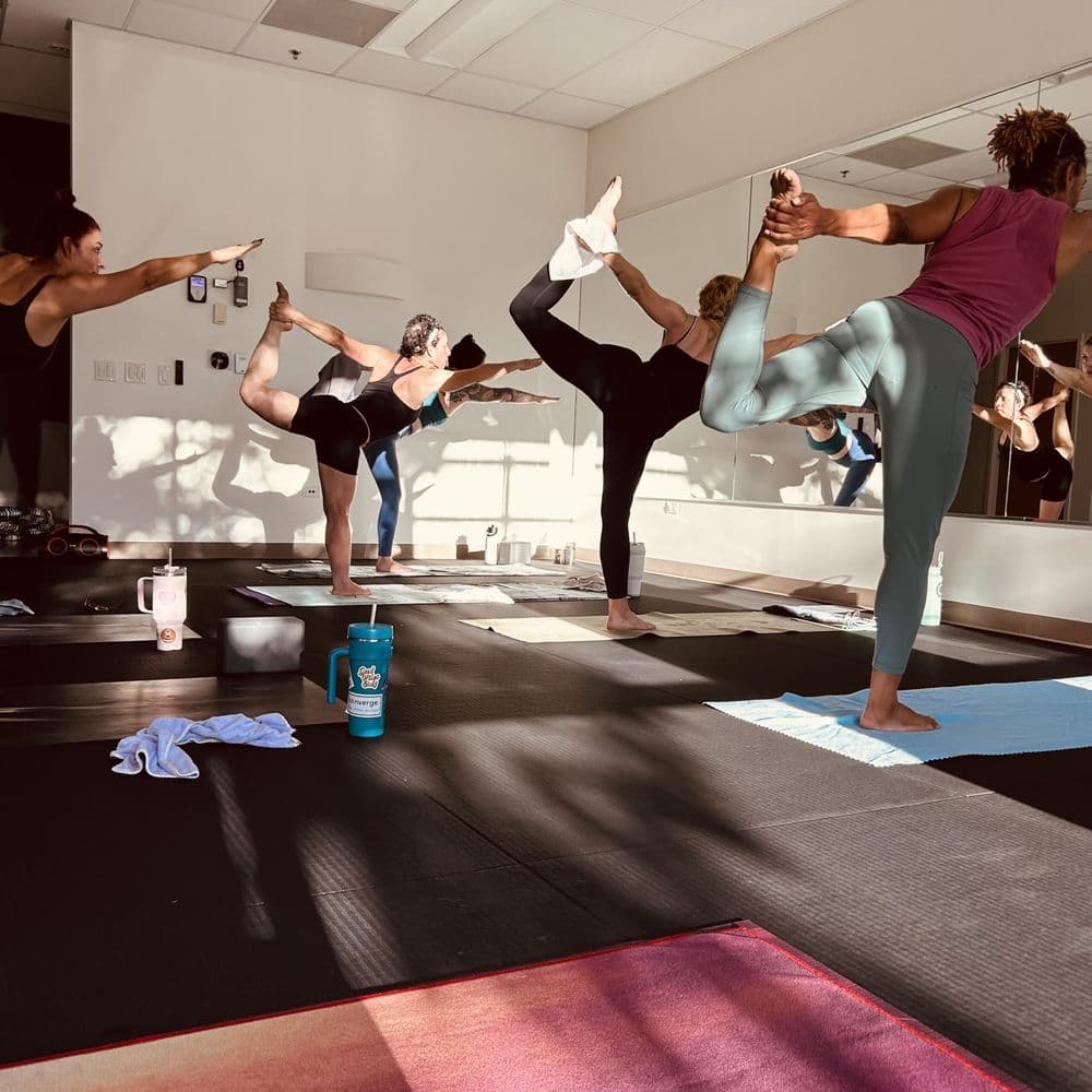 Yoga class practicing together in a bright studio